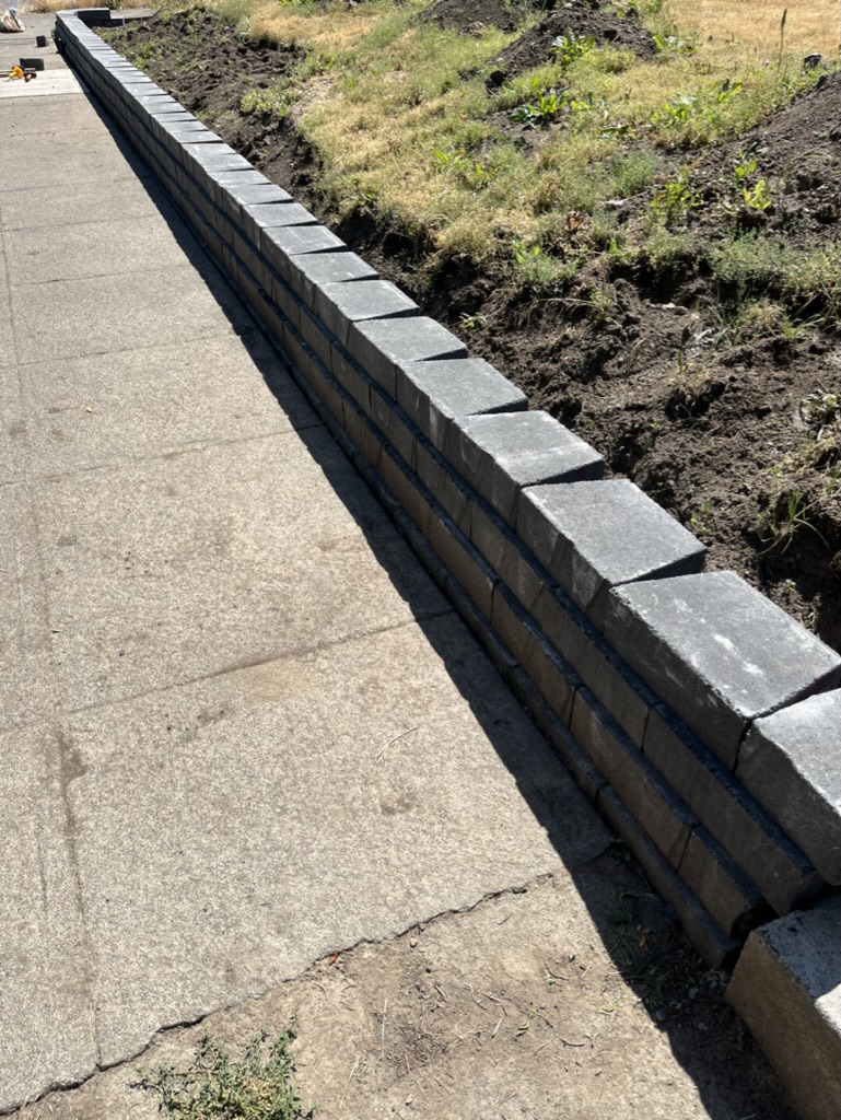 A half built retaining wall in front of house.